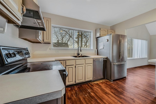 kitchen featuring stainless steel appliances, sink, cream cabinetry, and dark hardwood / wood-style floors