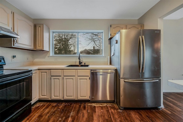 kitchen featuring stainless steel appliances, dark wood-type flooring, and sink