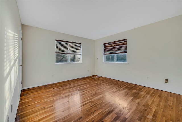 unfurnished room with light wood-type flooring