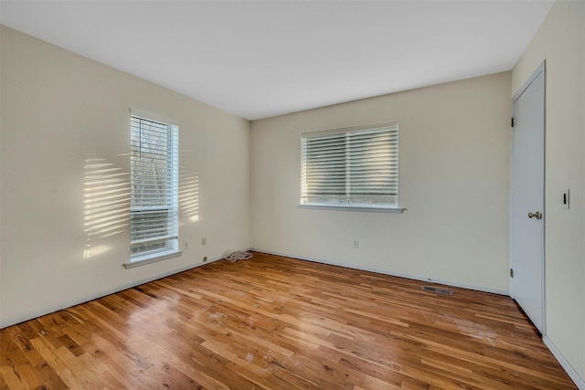 spare room featuring light wood-type flooring