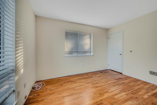 spare room featuring light hardwood / wood-style floors