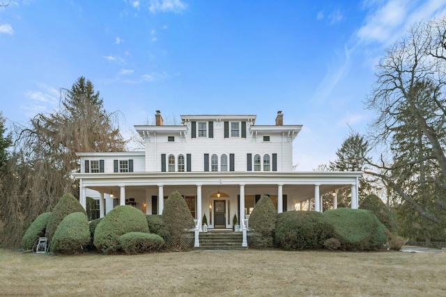 view of front of house with a porch and a front lawn