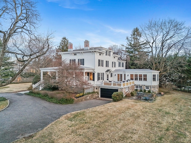 rear view of property featuring a lawn