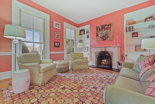 living room featuring light hardwood / wood-style floors and built in features