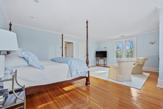 bedroom with hardwood / wood-style floors and crown molding