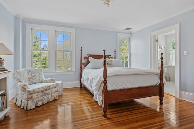 bedroom with crown molding and hardwood / wood-style flooring