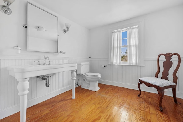 bathroom featuring wood-type flooring and toilet