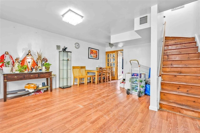 game room featuring french doors and light hardwood / wood-style floors