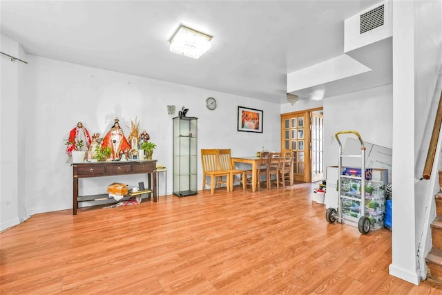 miscellaneous room featuring french doors and light hardwood / wood-style flooring