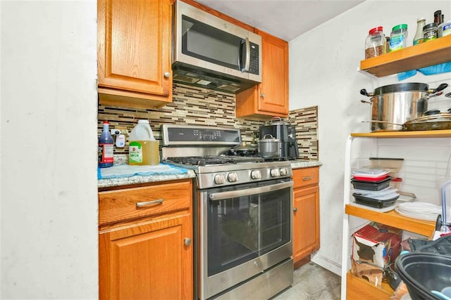 kitchen featuring decorative backsplash and appliances with stainless steel finishes