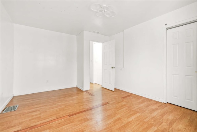 spare room featuring light wood-type flooring