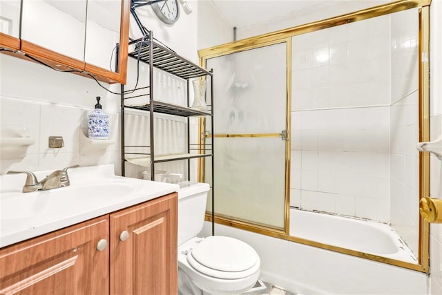 full bathroom featuring bath / shower combo with glass door, toilet, and vanity