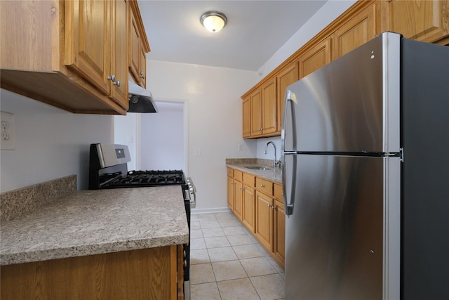 kitchen with stainless steel appliances, sink, and light tile patterned floors