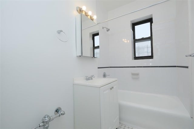 bathroom with vanity and tiled shower / bath combo