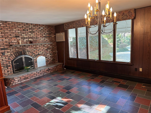 unfurnished dining area featuring an AC wall unit, wooden walls, and a chandelier