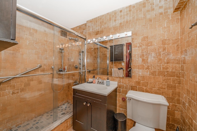 bathroom with an enclosed shower, vanity, and toilet