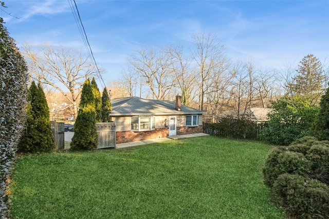 rear view of property featuring a lawn