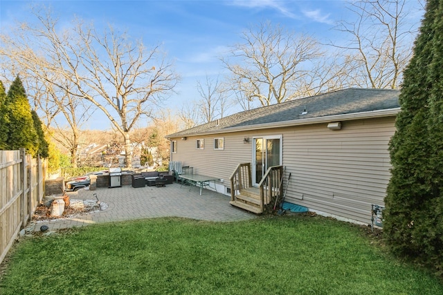 rear view of house featuring an outdoor living space, a patio, and a lawn