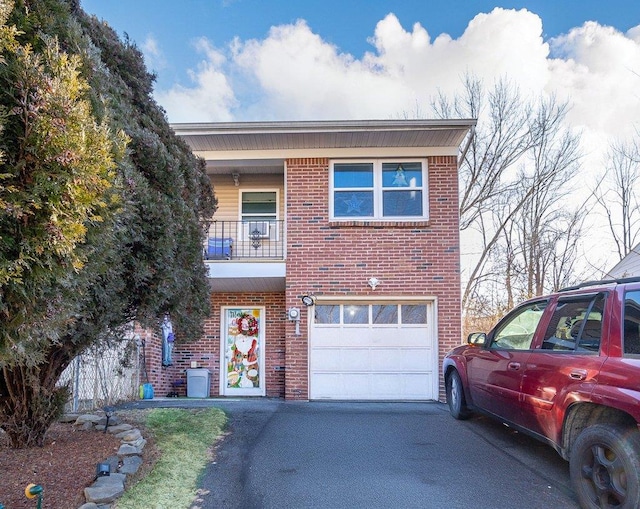 view of front of property featuring a garage and a balcony