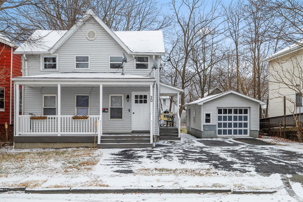 view of front of home featuring a garage, a porch, and an outdoor structure
