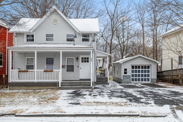 view of front of home featuring a garage, a porch, and an outdoor structure