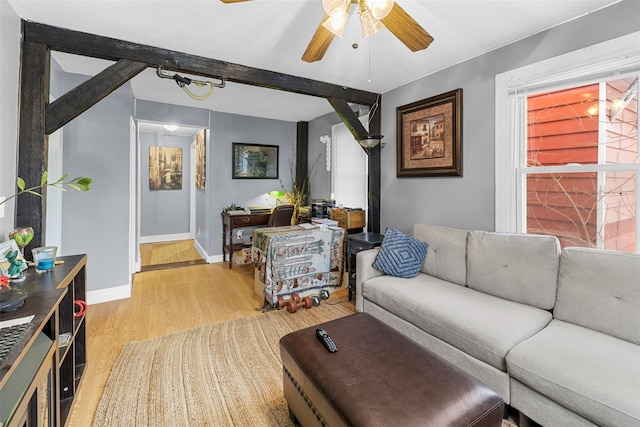 living room with hardwood / wood-style flooring, beam ceiling, and ceiling fan