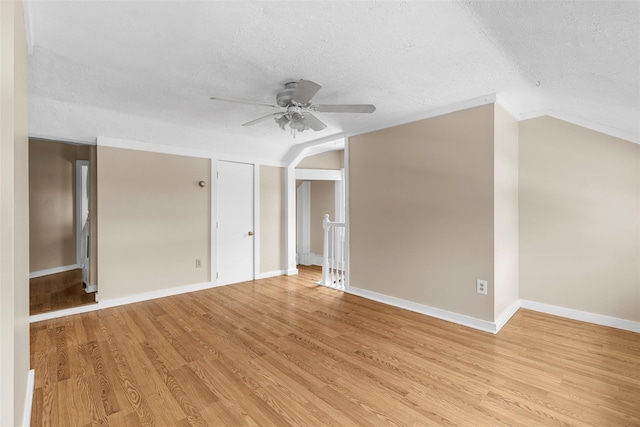 bonus room with a textured ceiling, ceiling fan, light hardwood / wood-style flooring, and lofted ceiling