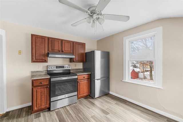 kitchen featuring stainless steel appliances, ceiling fan, and light wood-type flooring