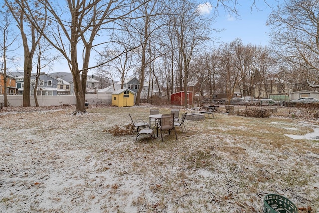 view of yard featuring a fire pit and a shed