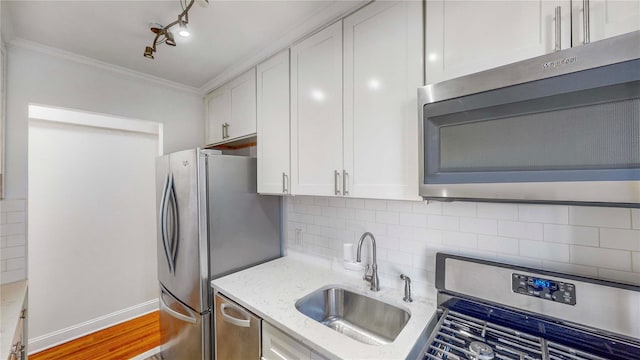 kitchen with sink, stainless steel appliances, and white cabinets