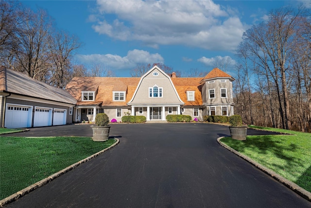 view of front facade with a front lawn and a garage