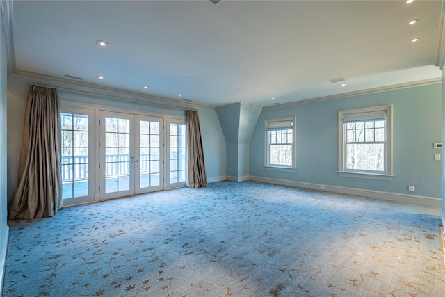 carpeted spare room featuring french doors and crown molding