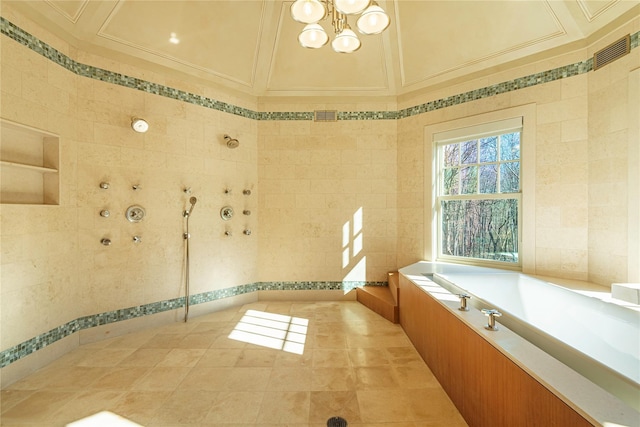 bathroom with a tub to relax in, crown molding, tile patterned floors, a notable chandelier, and tile walls