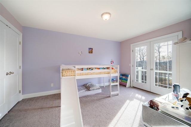 bedroom featuring access to outside, light carpet, and french doors