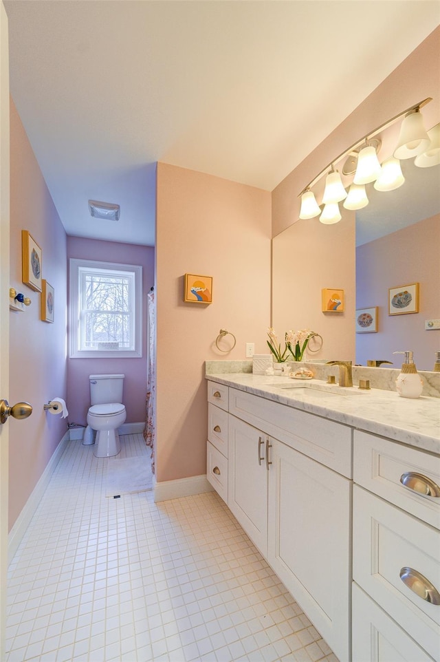 bathroom with tile patterned floors, vanity, and toilet