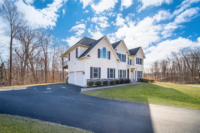 view of front of home with a front yard and a garage