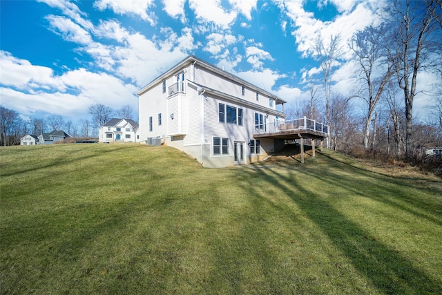 back of property featuring a lawn, cooling unit, and a deck