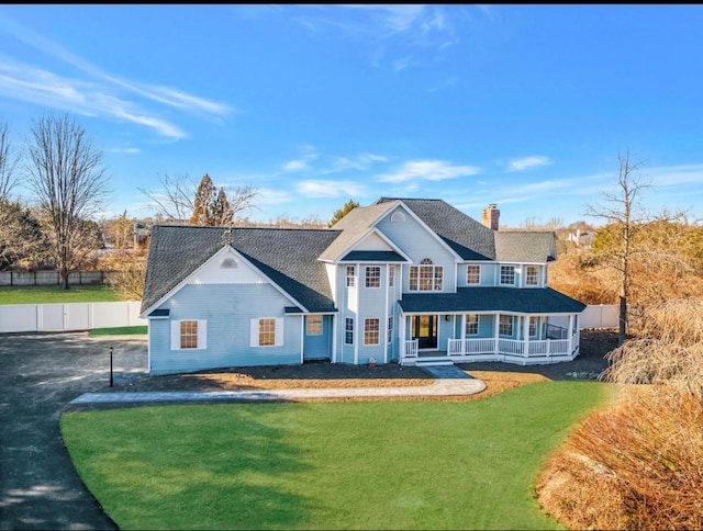 view of front of house with a porch and a front lawn