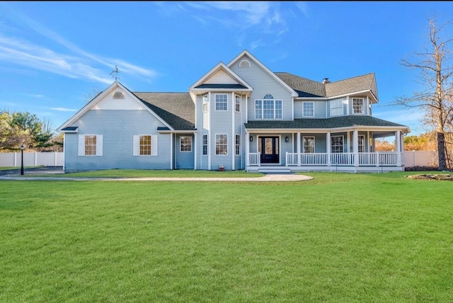 view of front facade featuring covered porch and a front yard