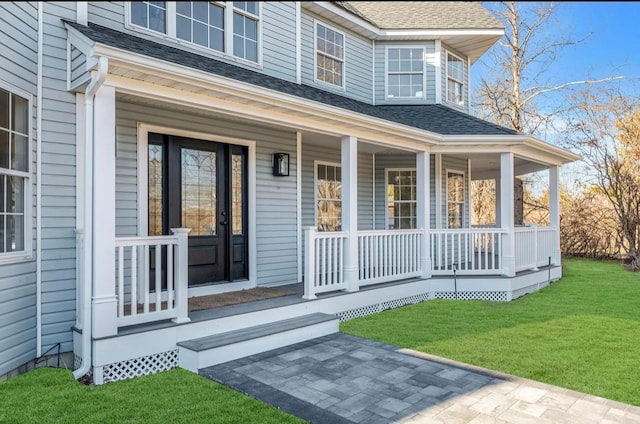 property entrance with a porch and a lawn