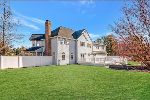 rear view of property with a lawn and a garage