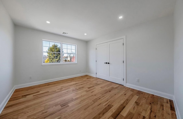 unfurnished bedroom featuring light wood-type flooring