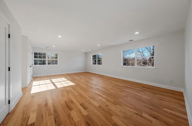 spare room featuring light wood-type flooring and a wealth of natural light