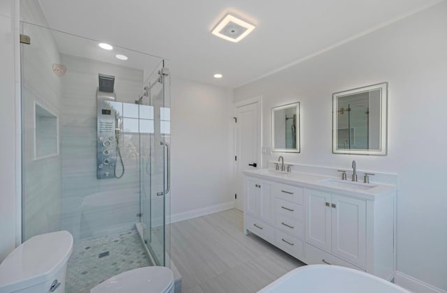 bathroom with toilet, a shower with door, and vanity