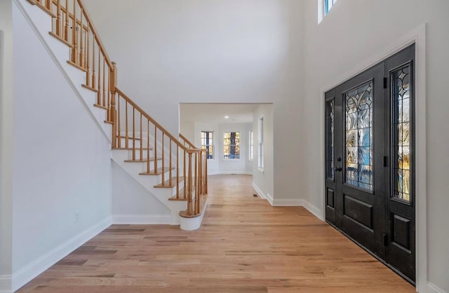 foyer entrance featuring plenty of natural light and light hardwood / wood-style flooring