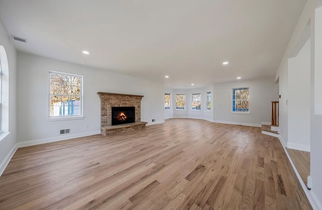 unfurnished living room featuring a fireplace and light wood-type flooring