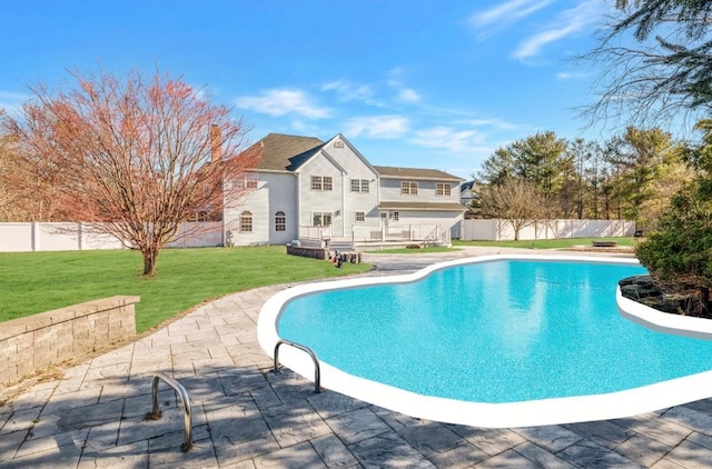 view of swimming pool featuring a patio and a yard