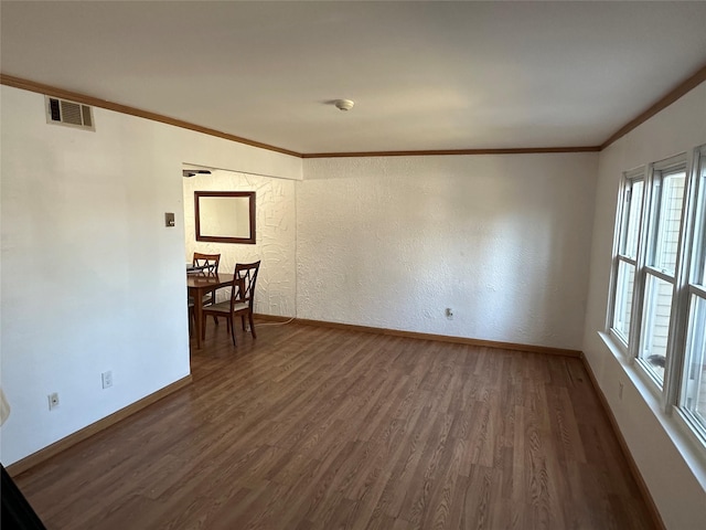 empty room with crown molding and dark hardwood / wood-style floors