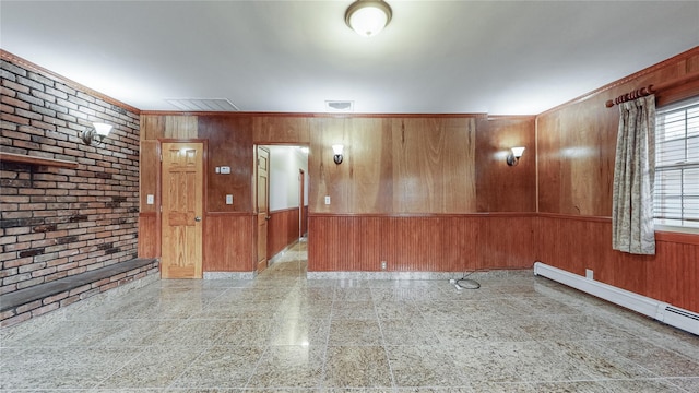 empty room with wooden walls, brick wall, and a baseboard heating unit