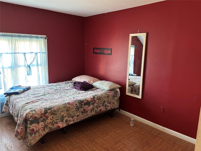 bedroom featuring parquet flooring